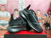 Angled side view showing the black upper, Under Armour logo, laces, and textured outsole.