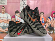 Pair of black, grey, and red Nike basketball shoes shown at an angle