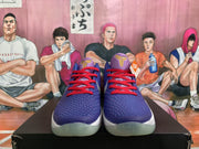 Front view of purple Nike basketball sneakers with red laces, textured uppers, and translucent outsoles.