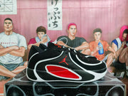 Side profile of black and red basketball sneakers with white accent lines and a low-cut silhouette.