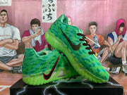 Angled view of the green sneaker pair showing the textured upper, side Swoosh, laces, and translucent outsole.