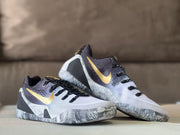Pair of white, black, and gold Kobe 9 GiGi sneakers shown from an angled front view.