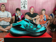 Side profile of an aqua and black Under Armour sneaker showing the visible logo, layered upper, dotted detailing, and sculpted black sole.