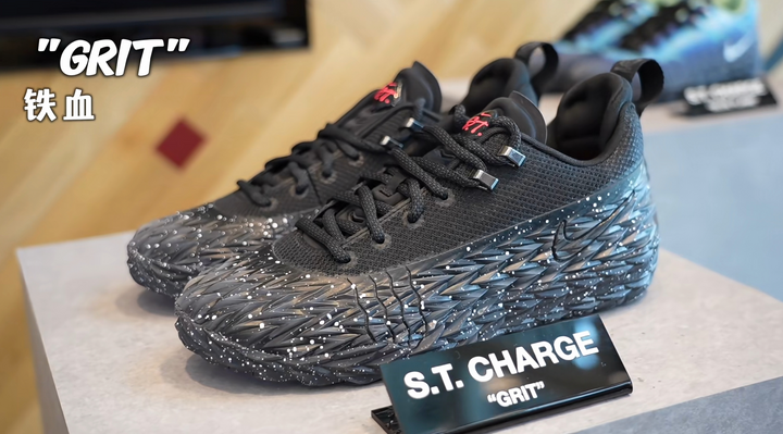 Pair of black 509-10 sneakers with GRIT and S.T. CHARGE markings, textured uppers, metallic-tone lace hardware, and sculpted speckled outsoles.