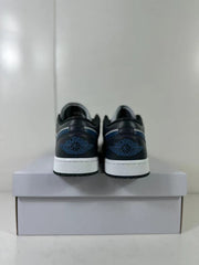 Rear view of black, grey, and blue low-top sneakers showing blue heel branding and white midsoles.