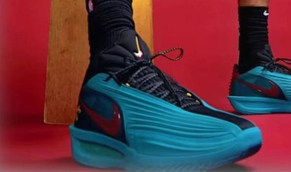 Blue and black Nike sneakers with a ridged upper, black laces, and contrasting swoosh branding against a red background.