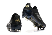 Rear views of black adidas F50 soccer cleats with gold heel accents and studded soles.
