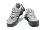 Pair of grey Nike Shox Ride 2 sneakers shown from above and at the front.