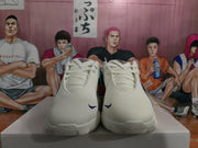 Front view showing the perforated white toe boxes, white laces, and small purple Nike swooshes.