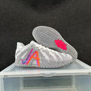 Nike basketball shoes shown from the side and outsole, highlighting the textured gray tread