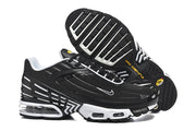 Pair of black and white Nike Air Max Plus III sneakers showing the outsole