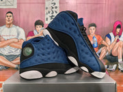 Angled view of the black and deep blue high-top sneakers