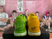 Rear view of the green and yellow Nike basketball shoes, showing their heel designs and midsoles.