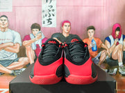 Front view of black and red Jordan Luka basketball shoes.