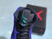 Close-up of the padded tongue, black laces, and turquoise Jumpman detail.