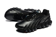 Pair of black Nike Air Max DN sneakers shown at an angled view