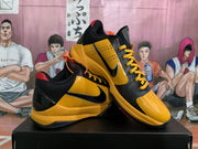 Angled view of the pair highlighting the yellow perforated side panels, black overlays, red accents, and visible Swoosh branding.