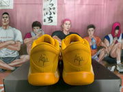 Rear view showing padded yellow collars and A'ja signature-style heel markings.