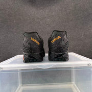 Rear view of black basketball shoes with gold-colored TWELVE lettering