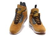 Front view of tan Nike Air Max 90 high-top shoes with black laces and gray lace panels