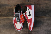 Top-down view of red, white, and black low-top sneakers showing the insoles, Nike Air labeling, side branding, and black button-style details.