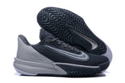 Nike Precision 7 basketball shoe in black and gray, shown with its patterned outsole facing up.