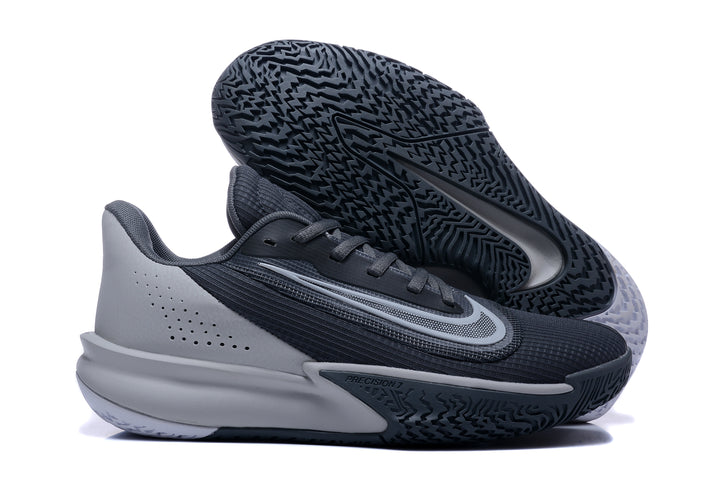 Nike Precision 7 basketball shoe in black and gray, shown with its patterned outsole facing up.