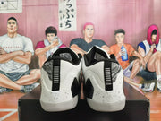 Rear view of white and black Nike Kobe basketball shoes with speckled heel panels.