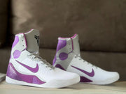Pair of white and purple high-top basketball shoes shown from the side.