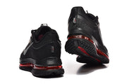 Rear view of black Nike Pegasus Premium shoes showing heel details and red sole accents.