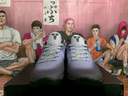 Front view of the black and purple basketball sneakers with light laces and Kobe emblems visible on the tongues.