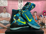 Pair of blue and black high-top basketball shoes with bright volt accents, shown from an angled front and side view.