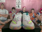 Front view of white basketball sneakers with pastel pink and green details, lime accents, and a chunky multicolor sole
