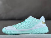 Side view of a mint, white, and gold Nike Kobe 3 low basketball shoe