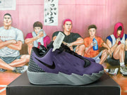 Side view of a purple and black Nike basketball shoe with a gray sculpted sole