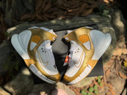 Top view of the pair showing gold overlays and white laces