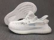 White sneaker shown from the side with the outsole visible; adidas and boost markings are visible in the image.