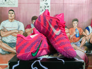 Pair of pink and purple sneakers displayed from angled side and outsole views, highlighting the patterned upper and translucent sole.