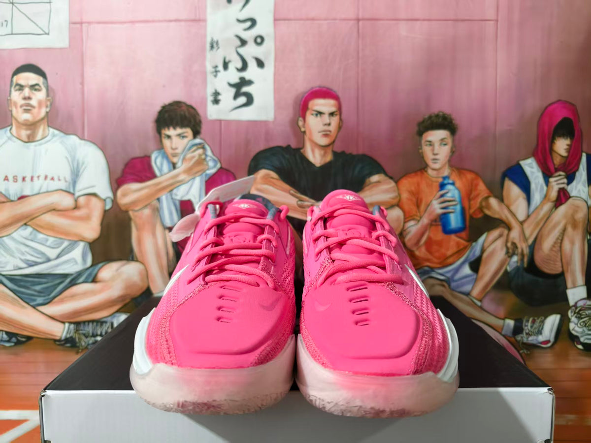 Front view of pink Nike basketball sneakers on a box