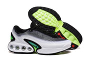 Nike Air Max sneakers shown from the side and outsole, highlighting black and bright green tread.