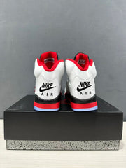 Rear view of the pair showing black heel branding, red midsole accents, and translucent outsole sections.