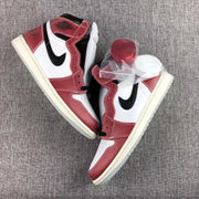 Overhead view of the pair with red and white spare laces in a clear bag.