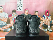 Rear view of black Jordan sneakers with Jumpman logos and elephant-print heel overlays