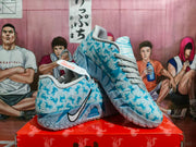 Angled view of the light blue Nike basketball sneakers, showing the padded collar, patterned upper, Swoosh branding, and textured outsole.