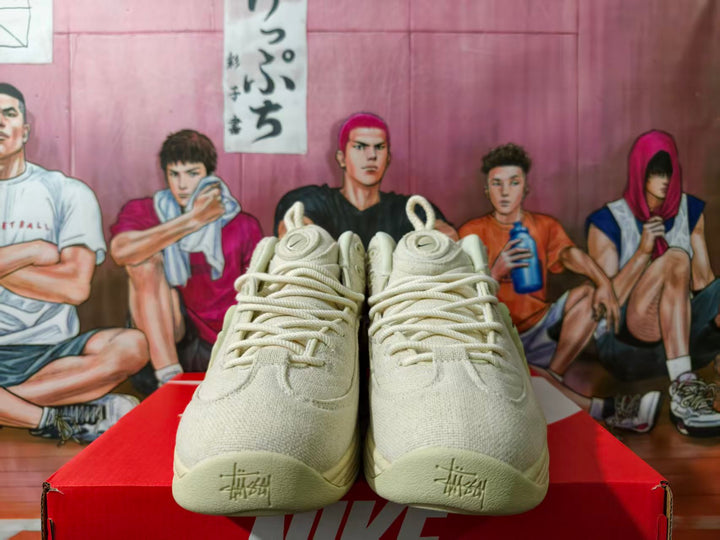 Front view of cream Nike basketball sneakers showing the laces and toe details.