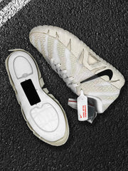 Side and underside view of one sneaker showing the textured upper, black Swoosh, and sole construction.
