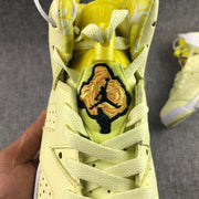 Close-up of the tongue showing the embroidered floral-style graphic and light-colored laces.