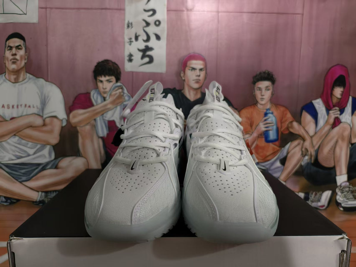 Front view of white and grey Nike LeBron basketball shoes with perforated uppers and white laces.