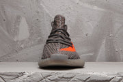 Front view of the grey Yeezy 350 V2 sneaker showing the lacing, knit-style upper, and translucent toe outsole.