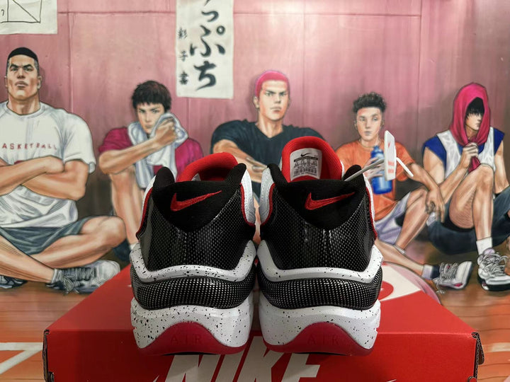 Rear view of white, red, and black Nike basketball shoes with speckled midsoles